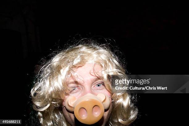 man wearing blonde wig and pig's snout mask - muzzle human stock pictures, royalty-free photos & images