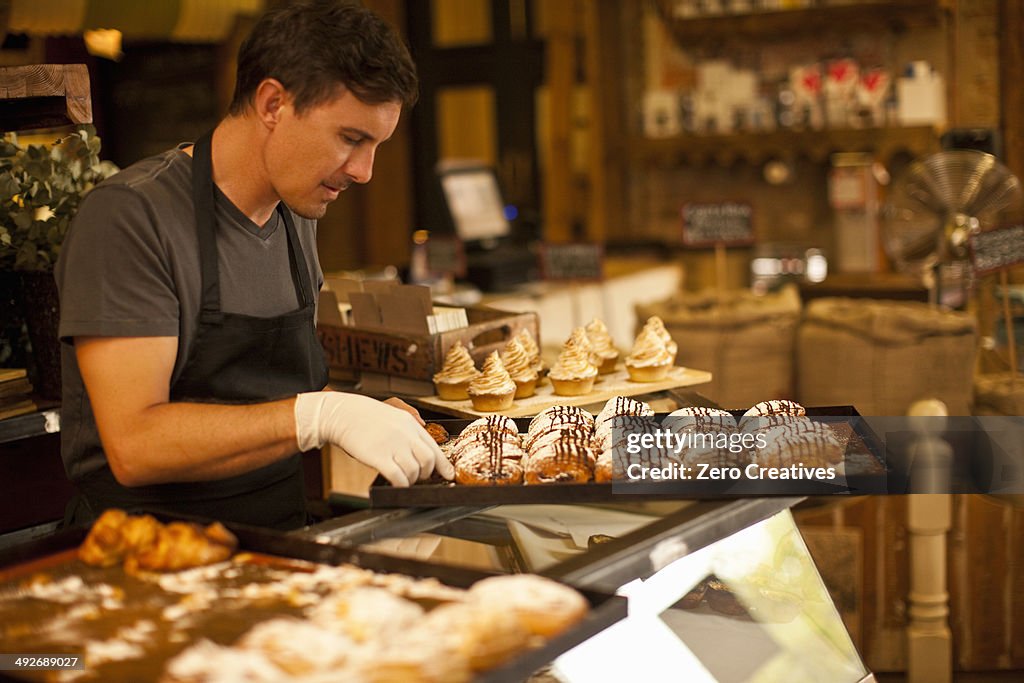 Mature man with tray of fresh pastries