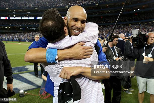 General manager Alex Anthopoulos and David Price of the Toronto Blue Jays celebrate the 6-3 win against the Texas Rangers as Ben Revere jumps on top...