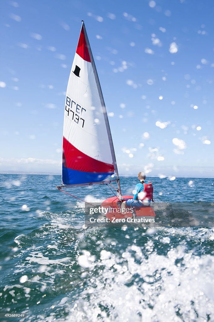 Teenager sailing boat