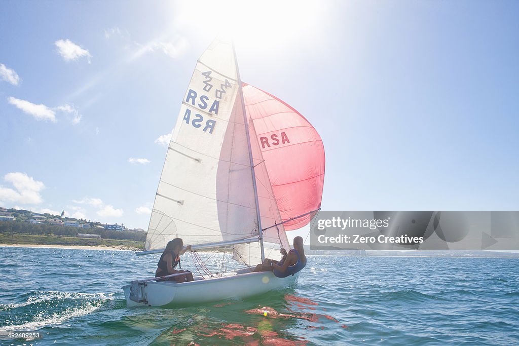 Teenager sailing boat