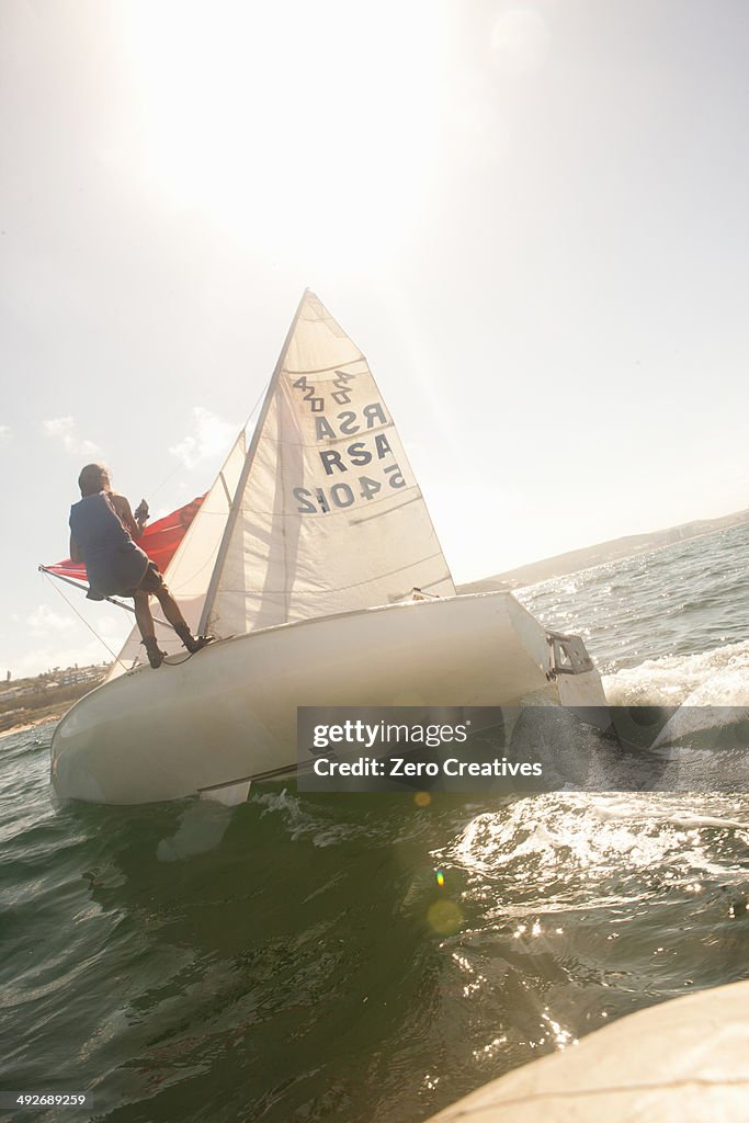 Teenager sailing boat