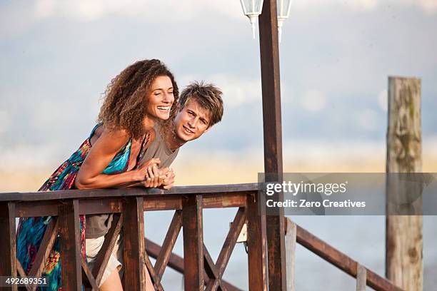 young couple on jetty - knysna stock-fotos und bilder