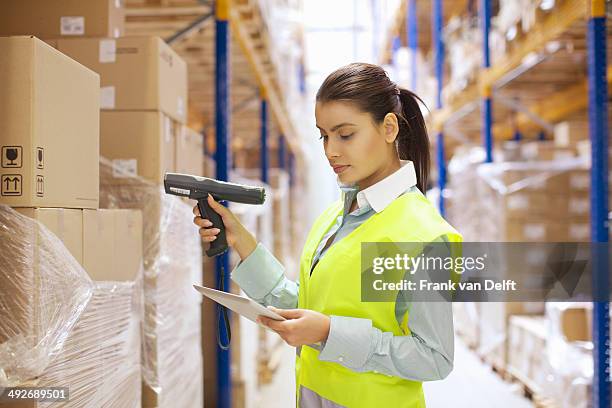 female warehouse worker using barcode reader - scanner stock stock pictures, royalty-free photos & images