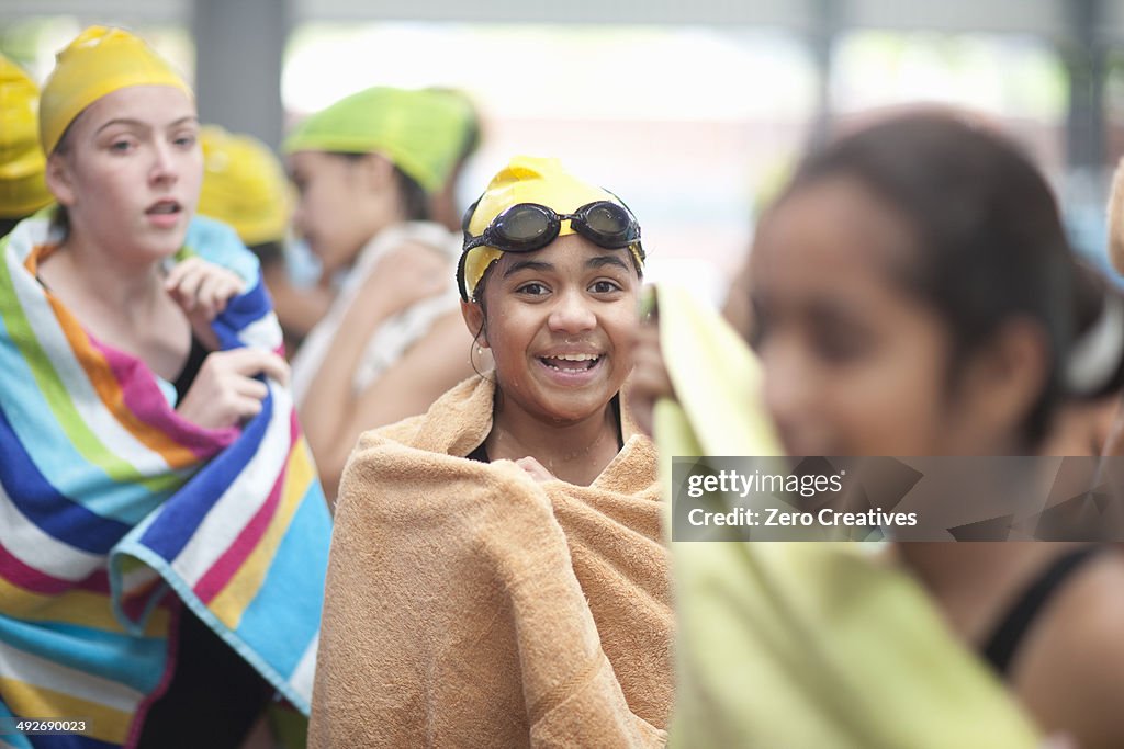 Group of schoolgirls wrapped in towels after swimming