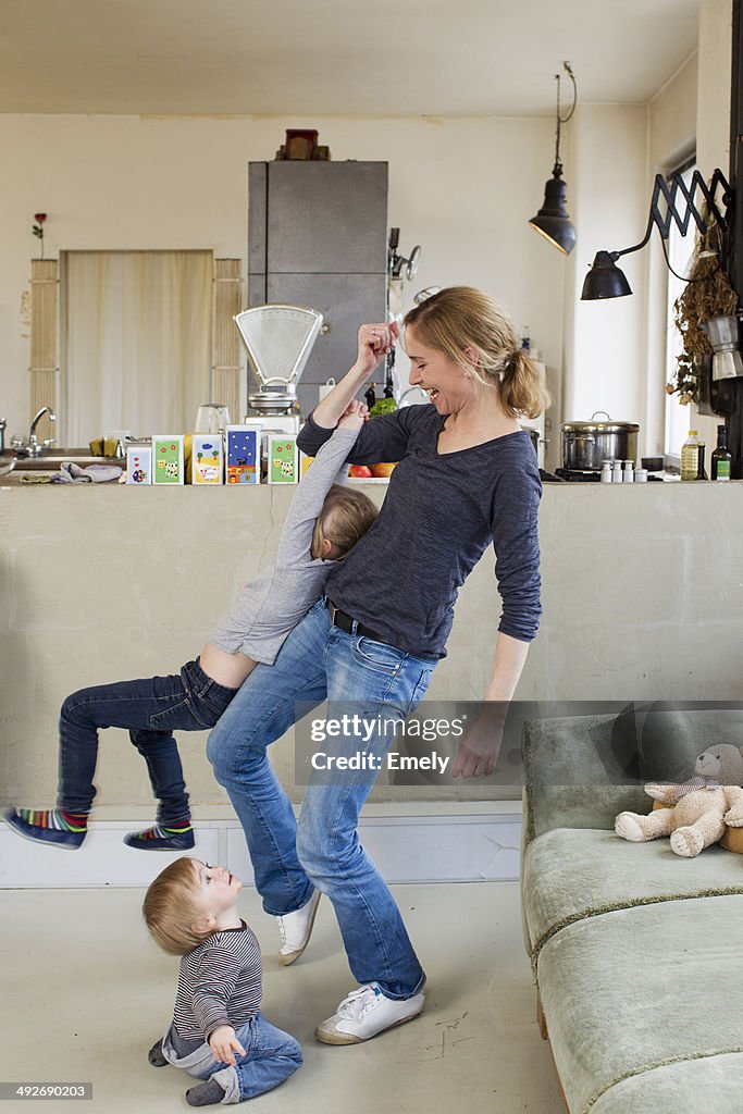 Mid adult mother playing with her two young daughters