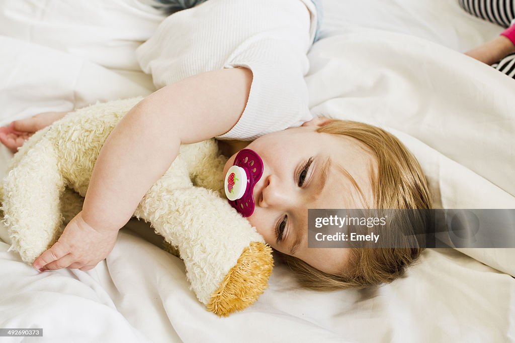 Baby girl asleep with teddy bear