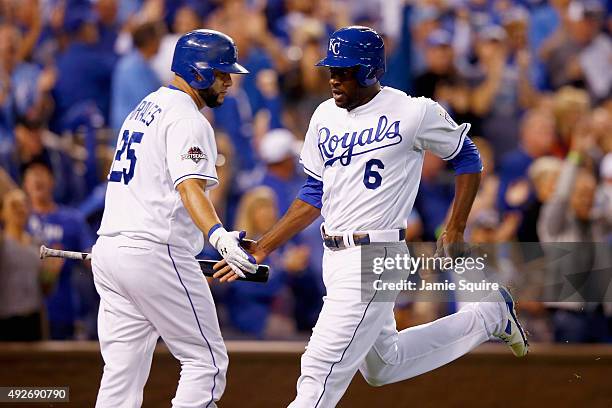 Lorenzo Cain of the Kansas City Royals celebrates with Kendrys Morales of the Kansas City Royals after scoring a run in the fourth inning after Eric...