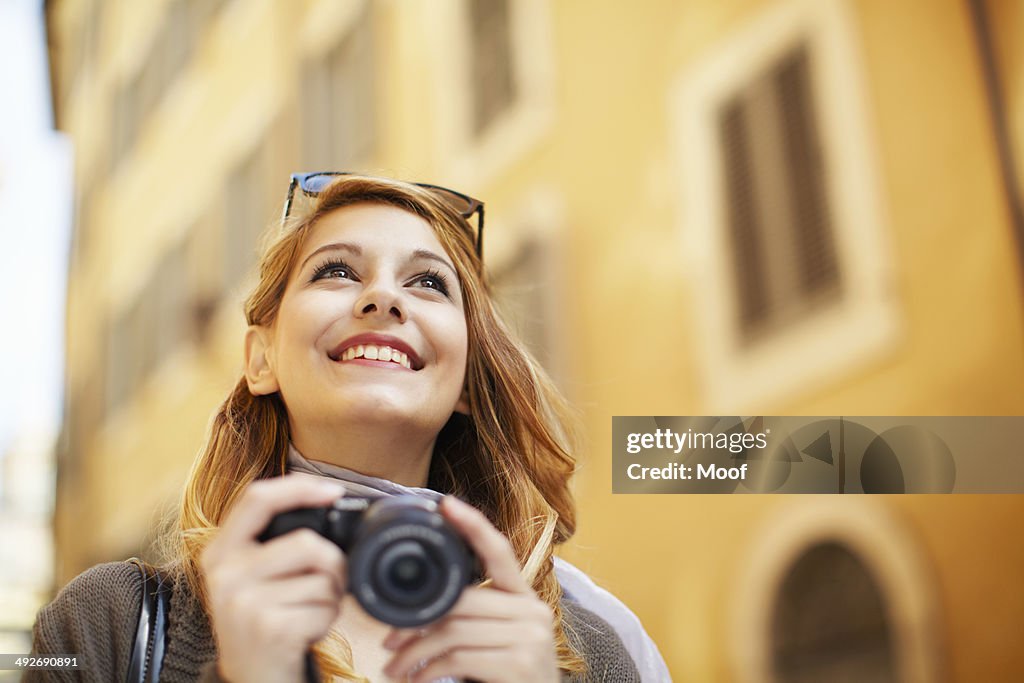 Young woman with digital camera, Rome, Italy
