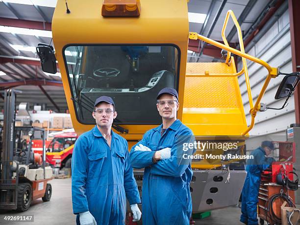 portrait of engineers in truck repair factory - monty rakusen portrait stock pictures, royalty-free photos & images