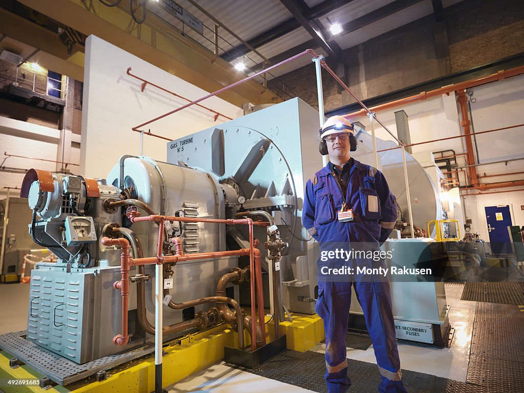 Portrait of engineer in generator room of power station