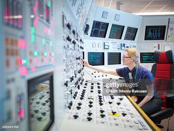 female operator in nuclear power station control room simulator - energia nucleare foto e immagini stock