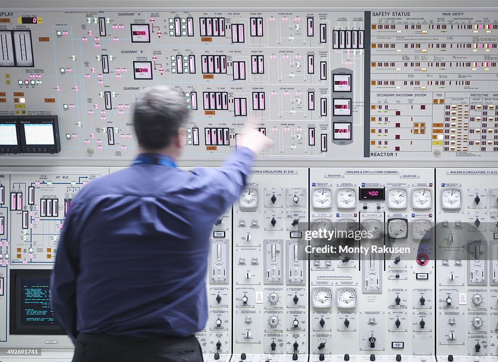 Operator adjusting controls in nuclear power station control room simulator