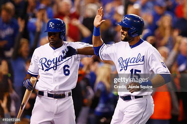 Alex Rios of the Kansas City Royals celebrates with Lorenzo Cain of the Kansas City Royals after scoring a run in the fifth inning against the...