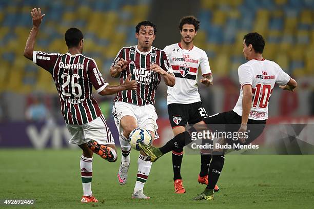 Fred and Breno Lopes of Fluminense battle for the ball with Paulo Henrique Ganso of Sao Paulo during a match between Fluminense and Sao Paulo as part...