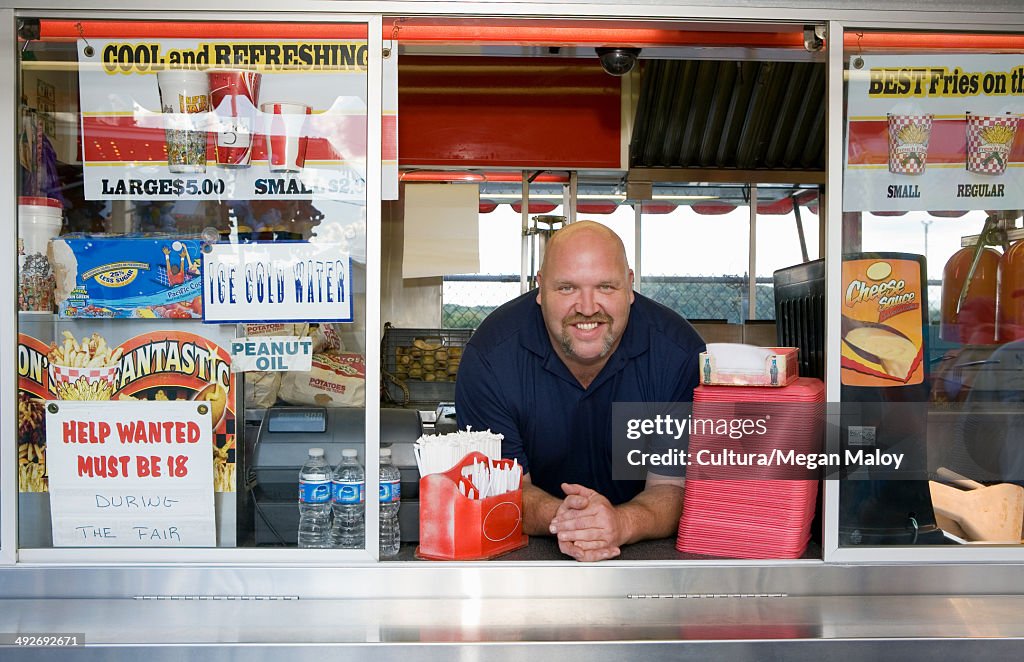 Owner of food stall at county fayre, smiling