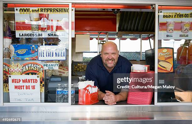 owner of food stall at county fayre, smiling - snackbar stock pictures, royalty-free photos & images