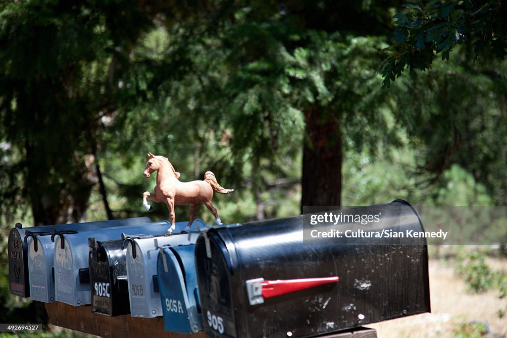 Rural mailboxes with plastic horse figurine