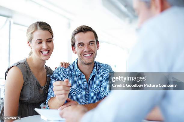 ensuring a bright financial future - couple signing stock pictures, royalty-free photos & images