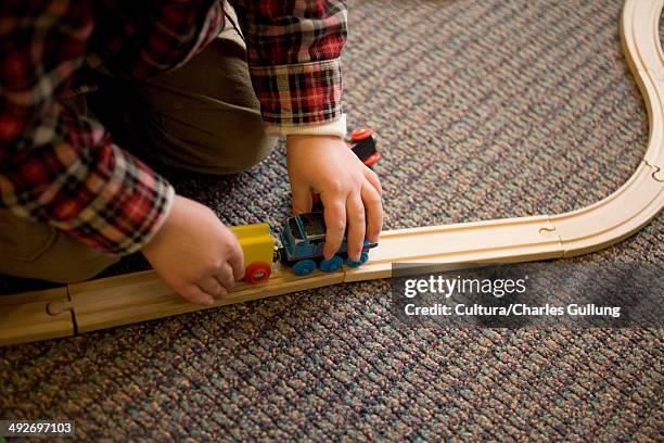 young boy playing with train set - model train stock pictures, royalty-free photos & images