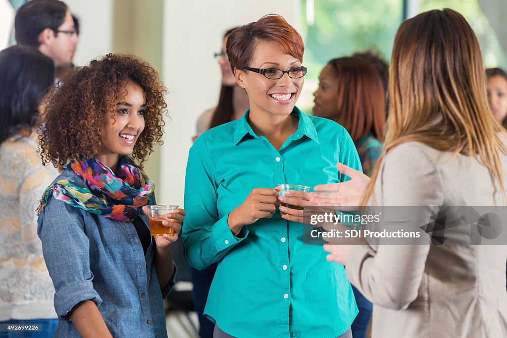 Mother and daughter at college meet and greet party