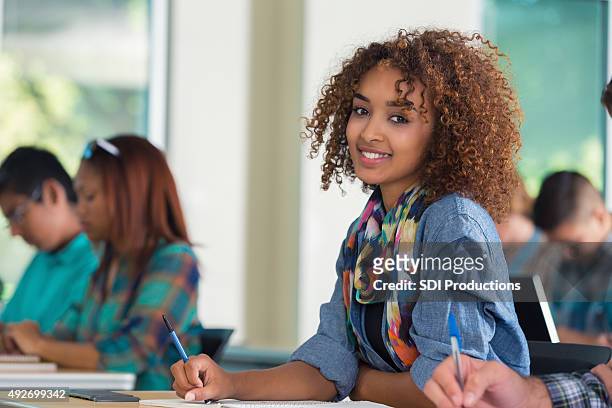 beautiful african american female teenage college student in classroom - beautiful college girls stock pictures, royalty-free photos & images