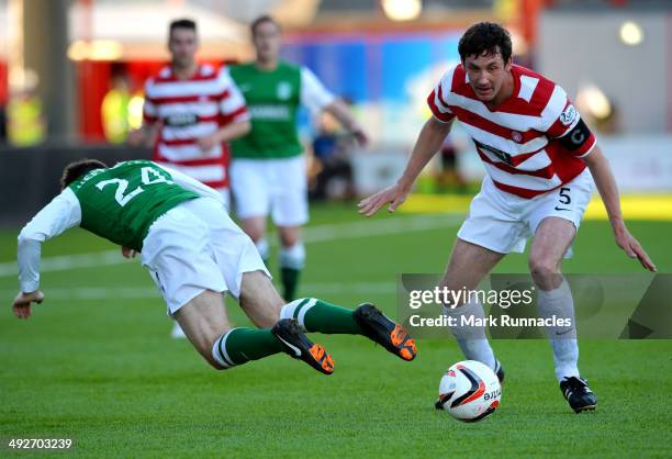 Jesus Garcia Tena of Hibernian is tackled by Michael Nelson of Hamilton Academical during the Scottish Premiership Play-off Final First Leg, between...