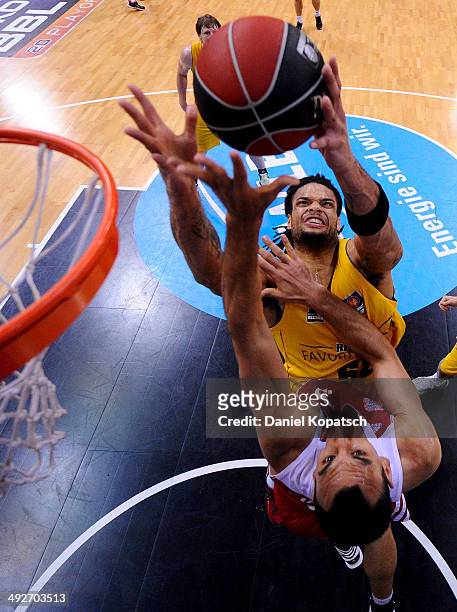 Yassin Idbihi of Muenchen is challenged by Gary McGhee of Ludwigsburg during the Beko BBL Playoffs semifinal match between MHP RIESEN Ludwigsburg and...
