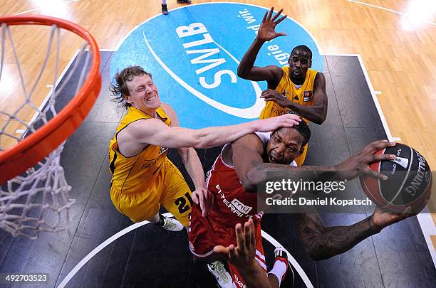 Deon Thompson of Muenchen is challenged by Coby Karl of Ludwigsburg during the Beko BBL Playoffs semifinal match between MHP RIESEN Ludwigsburg and...