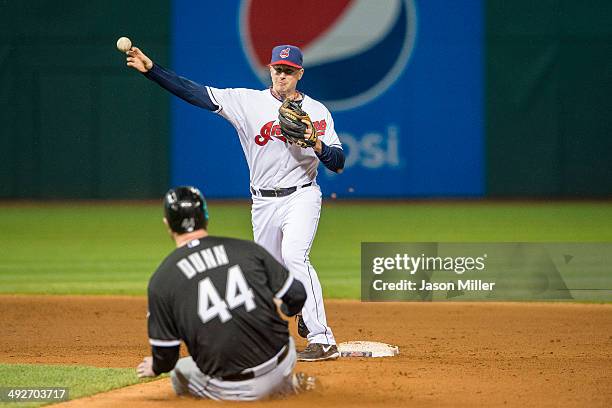 Second baseman Elliot Johnson of the Cleveland Indians throws out Dayan Viciedo at first as Adam Dunn of the Chicago White Sox is out at second for a...