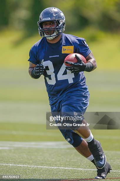 Running back Kiero Small of the Seattle Seahawks rushes during Rookie Minicamp at the Virginia Mason Athletic Center on May 17, 2014 in Renton,...
