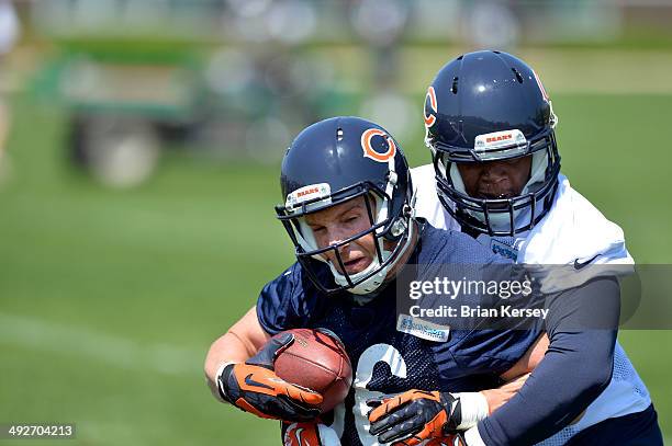 Linebacker DeDe Lattimore of the Chicago Bears tackles running back Jordan Lynch during rookie minicamp at Halas Hall on May 18, 2014 in Lake Forest,...