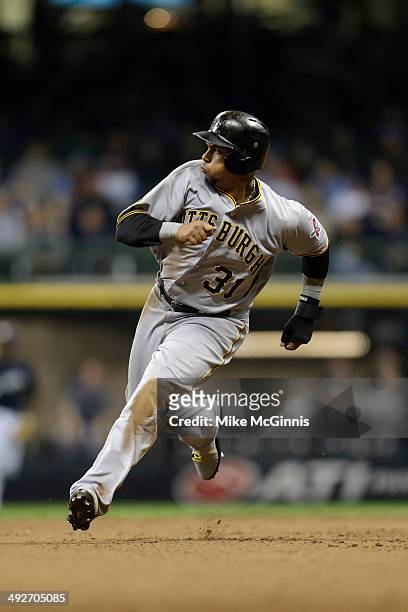 Jose Tabata of the Pittsburgh Pirates runs to third base during the game against the Milwaukee Brewers at Miller Park on May 13, 2014 in Milwaukee,...