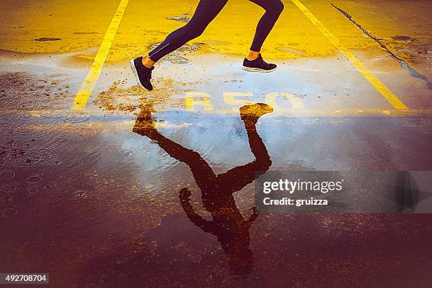 young person running over the parking lot - man feet stockfoto's en -beelden