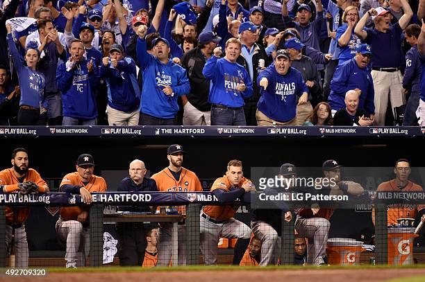 The Houston Astros look dejected in their dugout as Kansas City Royals fans cheer during Game 5 of the ALDS at Kauffman Stadium on Wednesday, October...