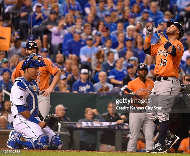 Kansas City Royals catcher Salvador Perez, left, watches as the Houston Astros' Luis Valbuena crosses the plate after hitting a two run home run in...