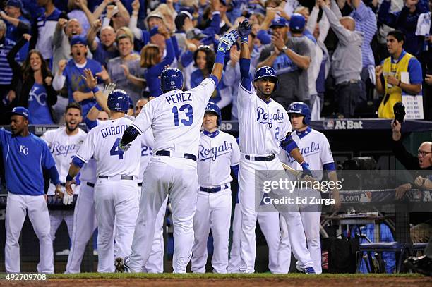 Alex Gordon of the Kansas City Royals and Salvador Perez of the Kansas City Royals celebrate with teammates after scoring runs in the fifth inning...