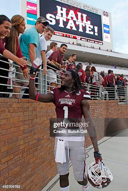 Wide receiver De'Runnya Wilson of the Mississippi State Bulldogs celebrates with fans after defeating the Troy Trojans in a NCAA college football...