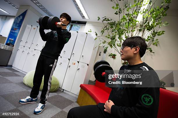 Kim Jun Hyuk, right, and Kim Do Gyeong, gamers of the SK Telecom T1 professional video-game team sponsored by SK Telecom Co., right, lift dumbbells...