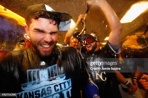 Eric Hosmer of the Kansas City Royals, left, celebrates with teammates in the clubhouse after defeating the Houston Astros 7-2 in game five of the...