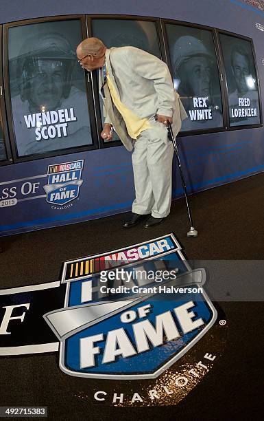 Wendell Scott, Jr., kisses the picture of his father, NASCAR driver Wendell Scott, after the announcement of the 2015 NASCAR Hall of Fame Class at...