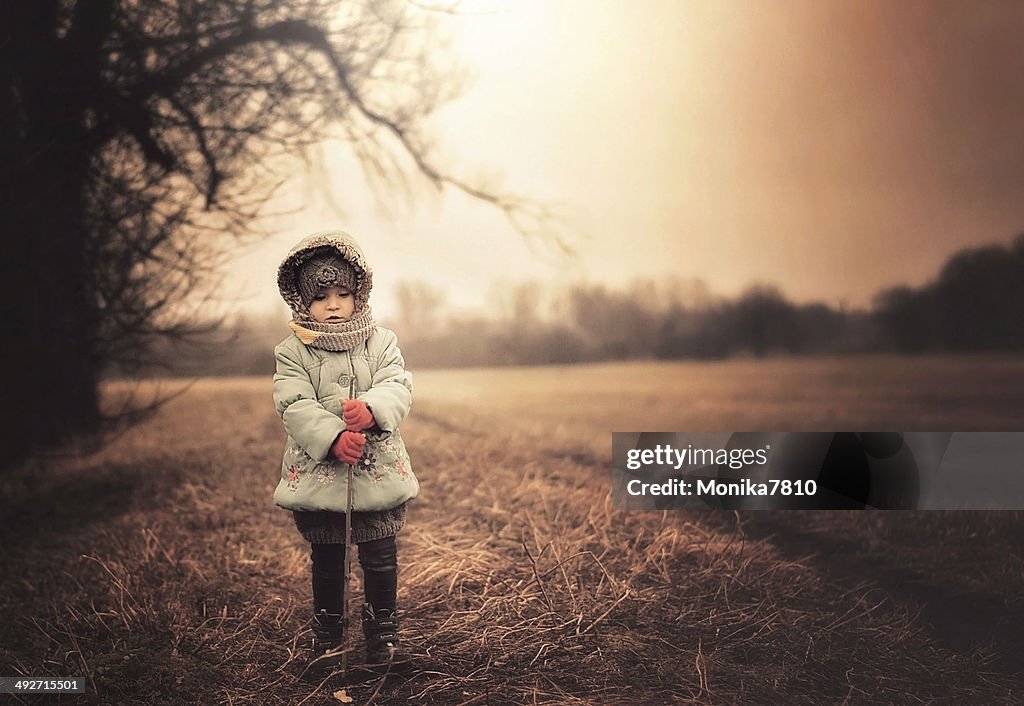 Poland, Girl wearing warm clothes standing on field