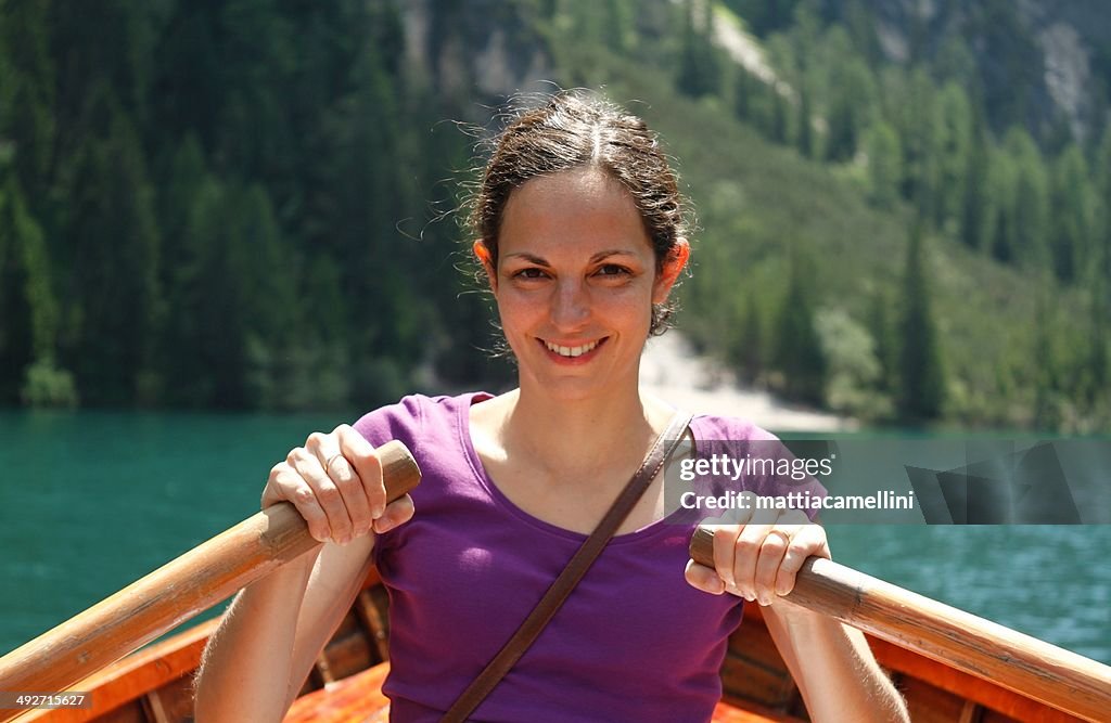 Portrait of a smiling woman in rowing boat on lake