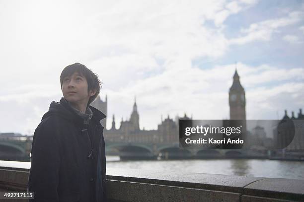 boy by river thames, palace of westminster in background, london - clock tower stock pictures, royalty-free photos & images