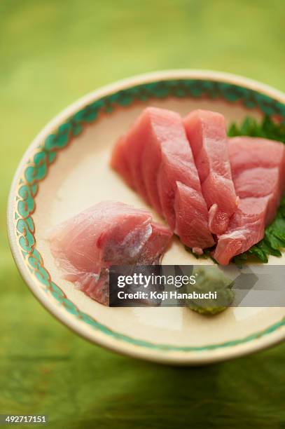 still life of raw sliced fish dish with leaves - wasabi paste stock pictures, royalty-free photos & images