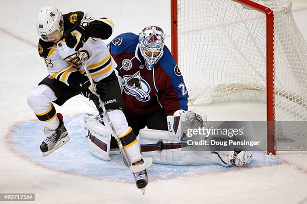 Goalie Reto Berra of the Colorado Avalanche makes a save a David Pastrnak of the Boston Bruins looks for the rebound at Pepsi Center on October 14,...