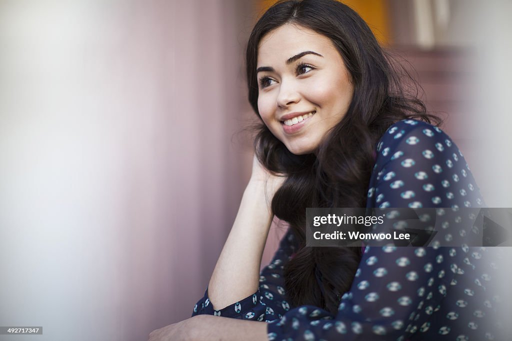 Young woman smiling and looking away