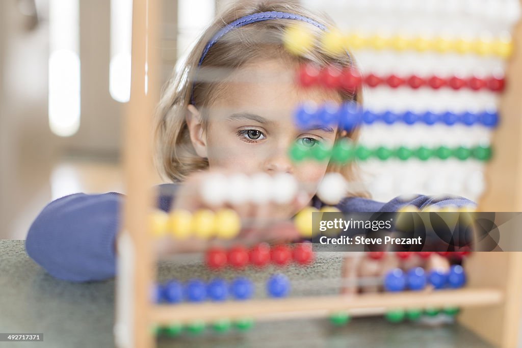 Young girl learning on abacus