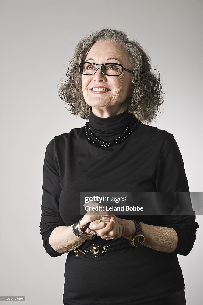 Portrait of senior woman, looking up