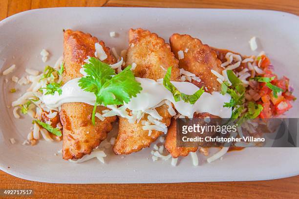aruban food, pastries with sauce and garnish on plate - aruba bildbanksfoton och bilder